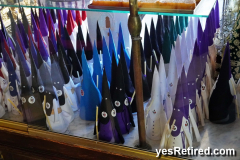 Nazarenos wearing Capirote pointy hats , Candy Store, Seville, Spain, 2024; easter
