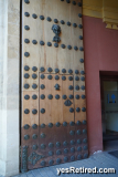 Door in a door, metal clad bottom, Seville, Spain, 2024